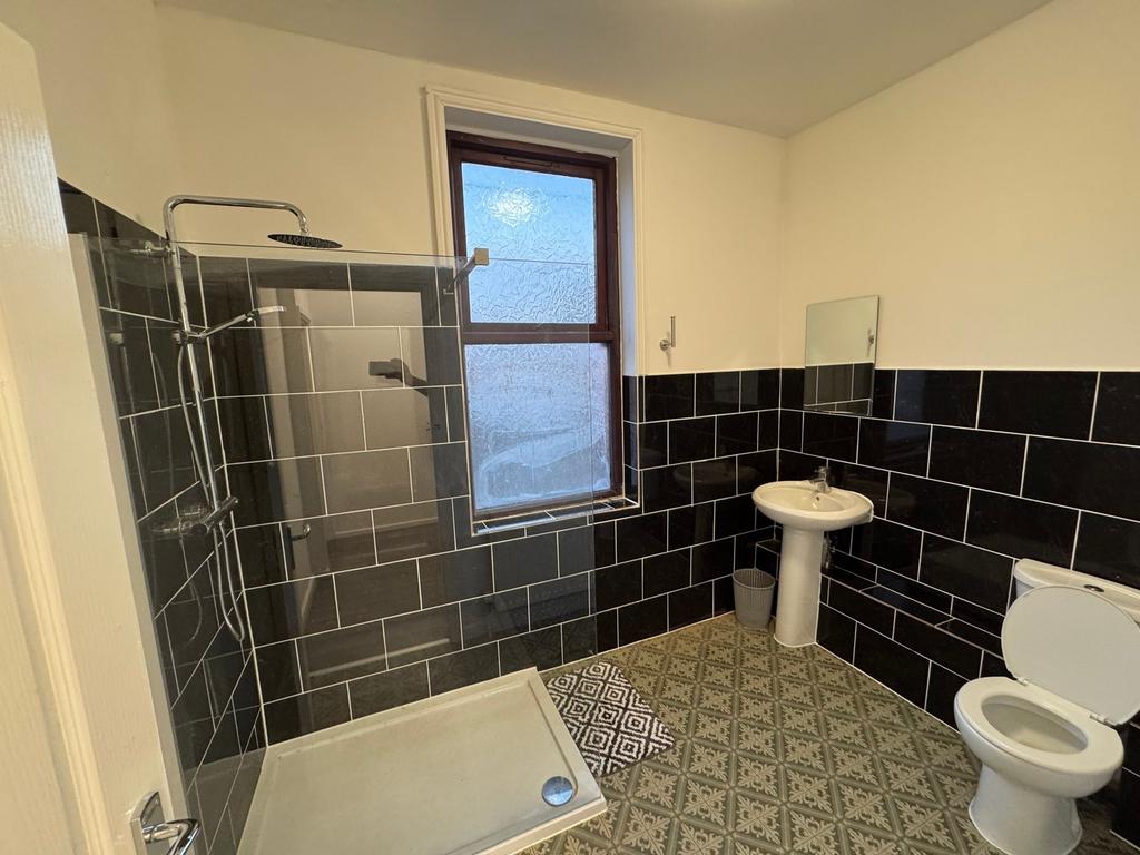 A modern bathroom featuring a walk-in shower wi...