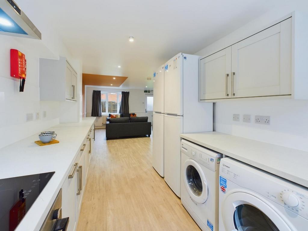 A bright and modern kitchenette with ample spac...
