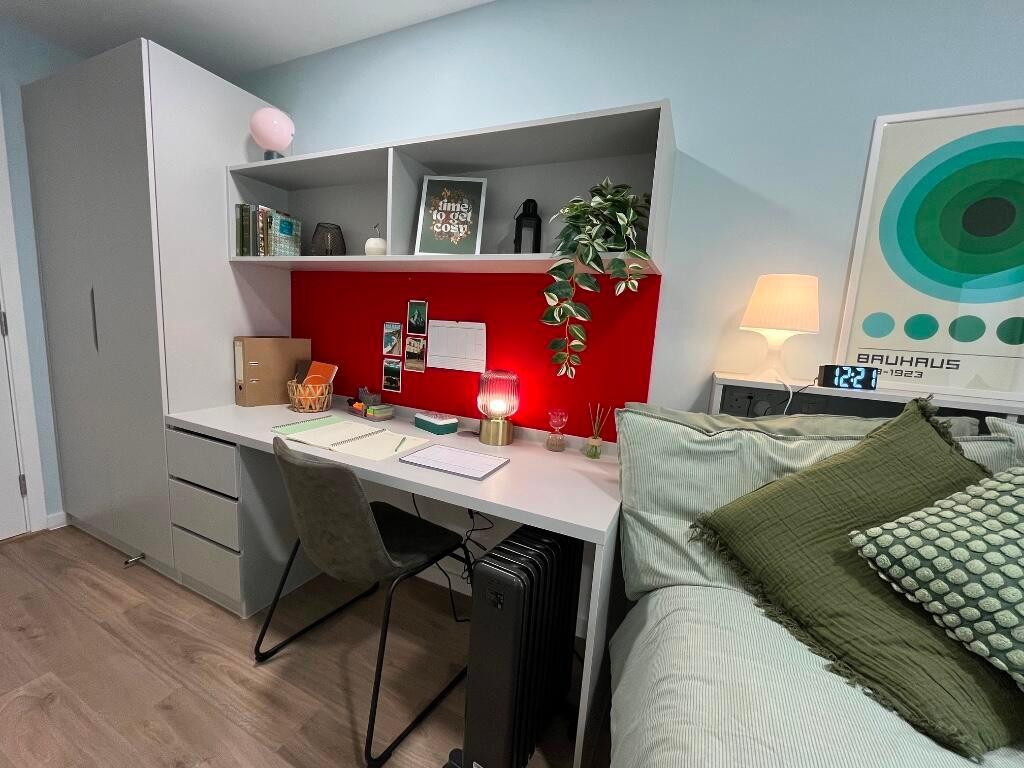 A cozy and well-organized bedroom featuring a c...