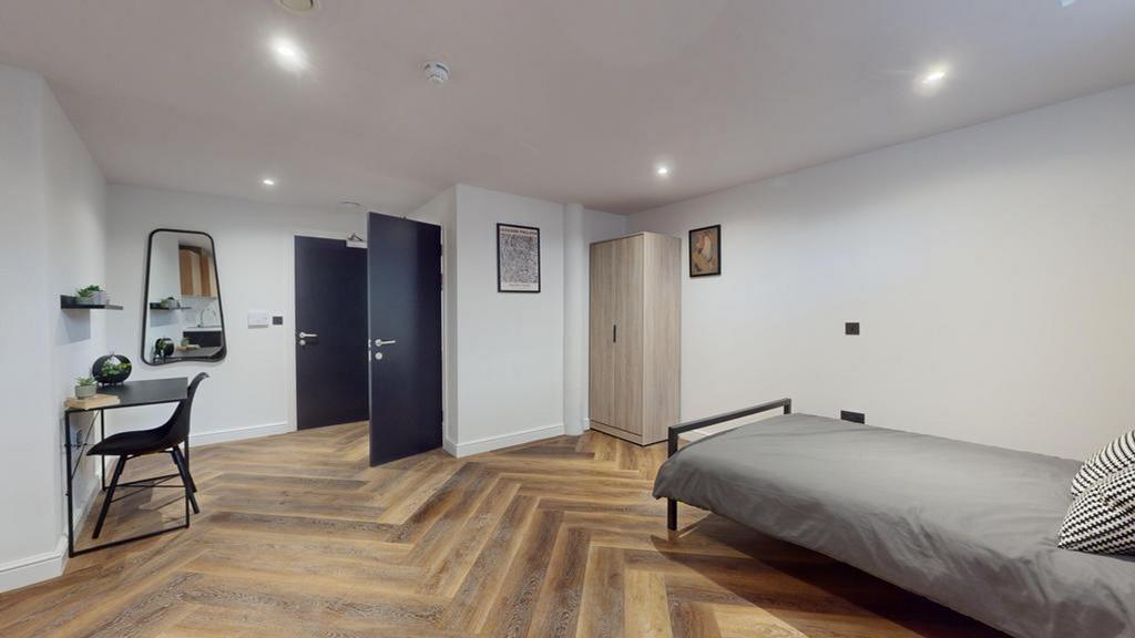 A spacious and well-lit double bedroom, featuri...