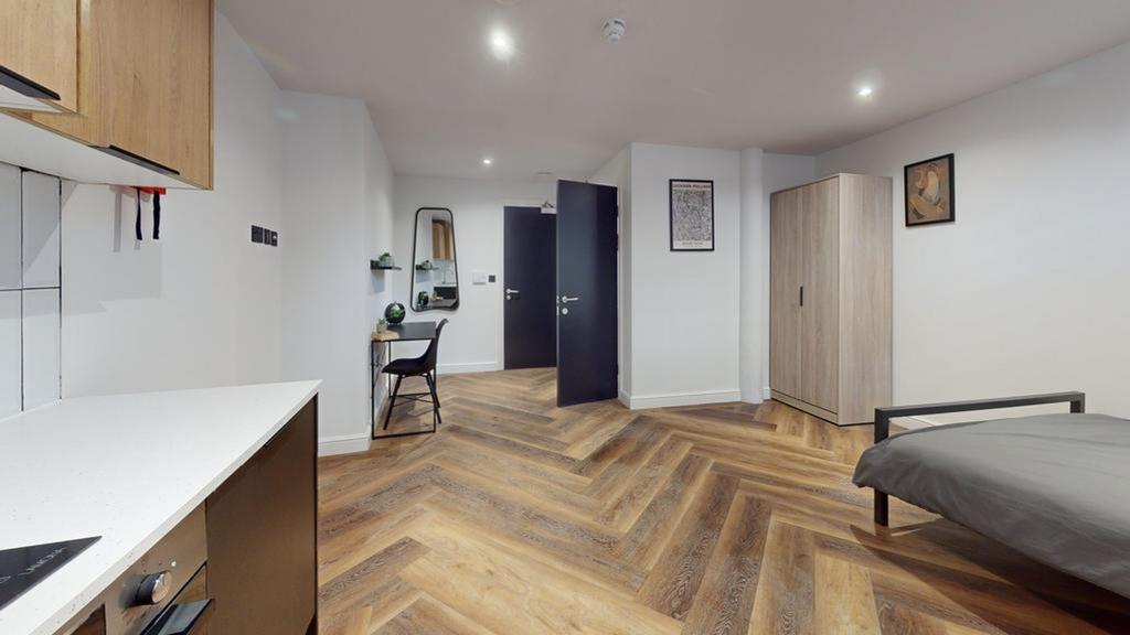A spacious and well-lit double bedroom with mod...