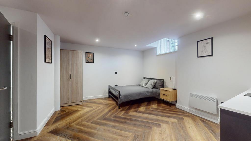 A spacious and well-lit double bedroom featurin...