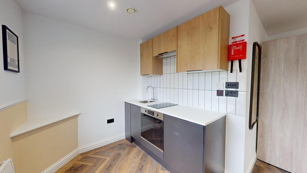 A modern and tidy kitchenette featuring sleek c...
