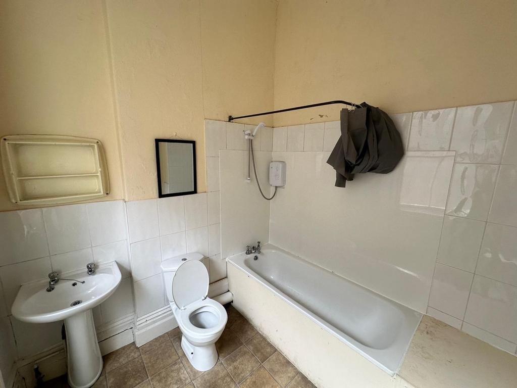 A functional bathroom featuring a bath and show...