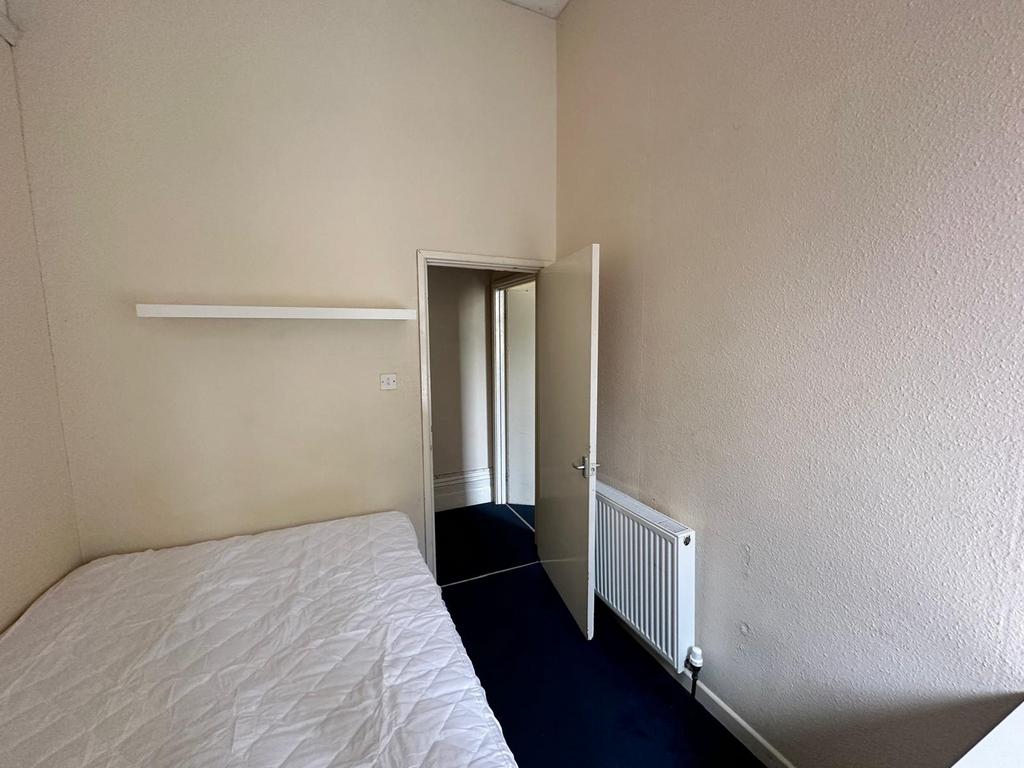 A cozy and tidy double bedroom with a welcoming...