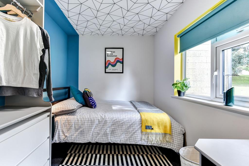 A cozy double bedroom featuring a vibrant color...