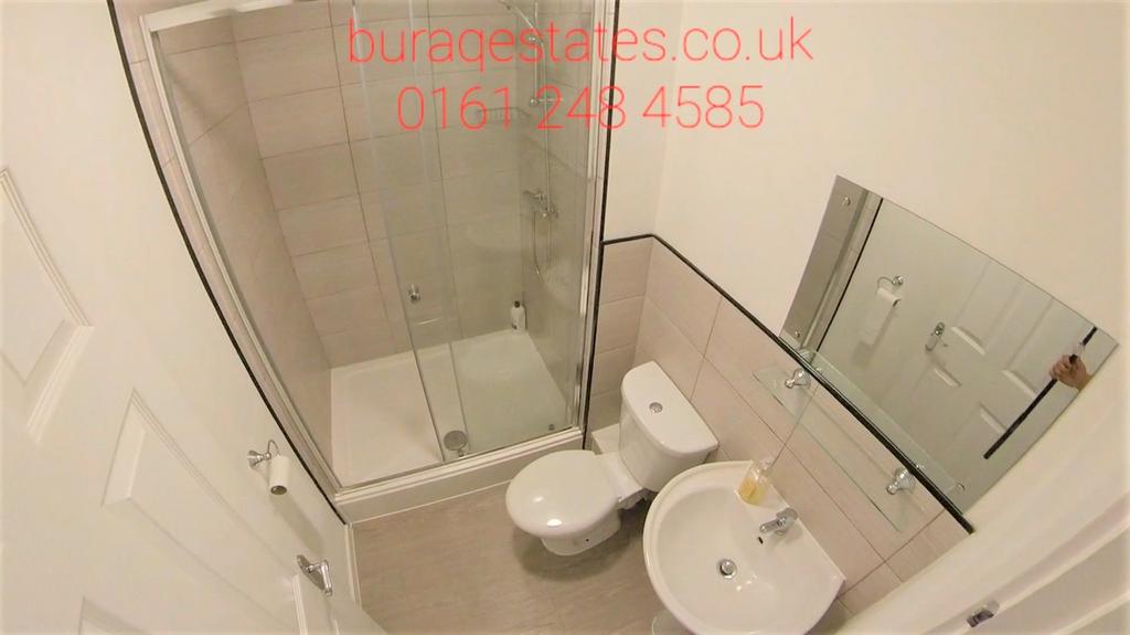 A compact and clean bathroom featuring a modern...