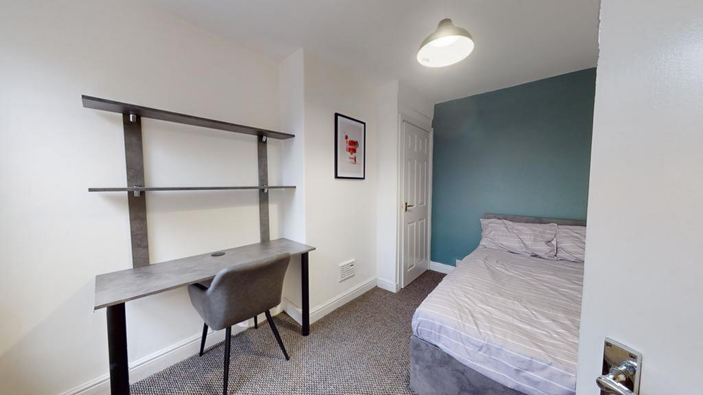 A bright and tidy double bedroom featuring a co...