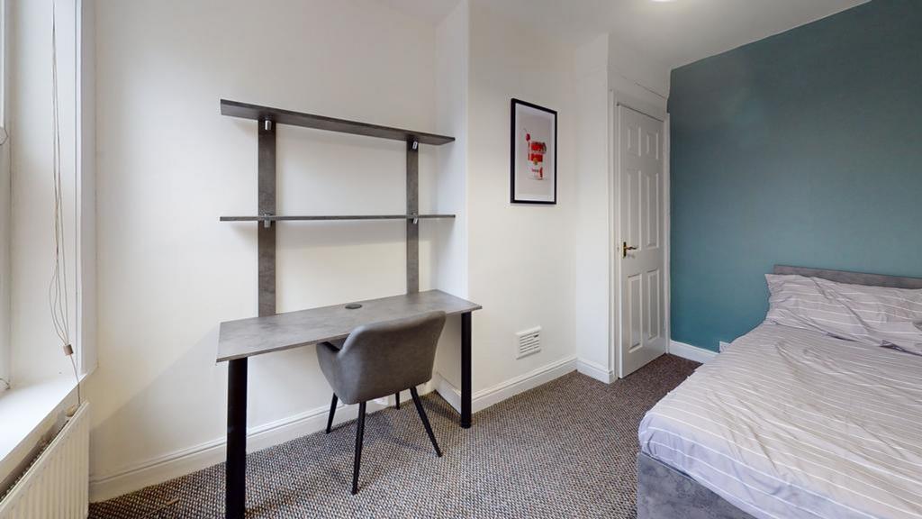A stylish and well-lit double bedroom with a mo...