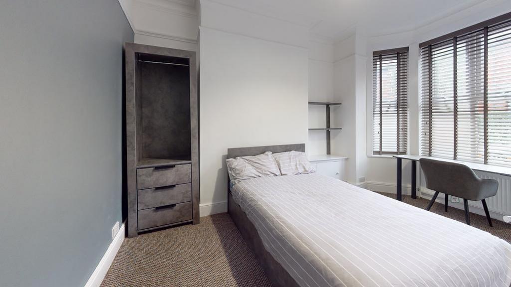 A clean and inviting double bedroom with ample ...