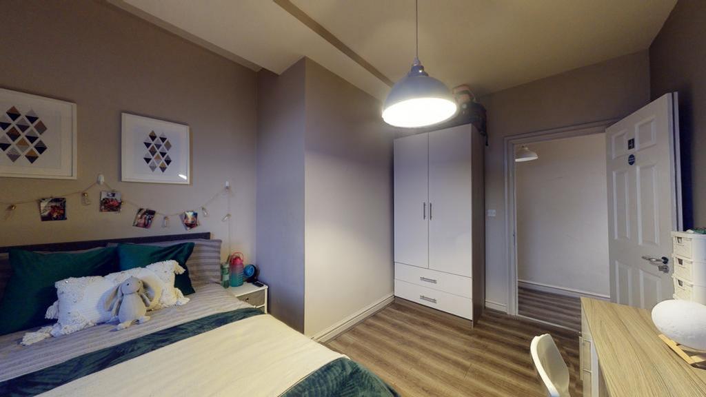 A bright and inviting double bedroom featuring ...