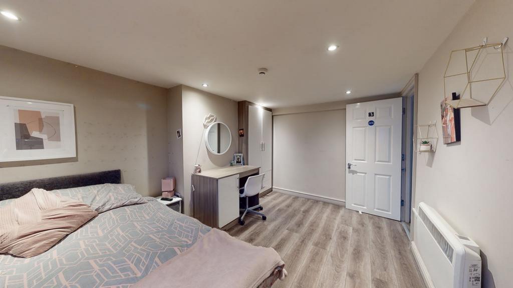 A spacious and inviting double bedroom featurin...