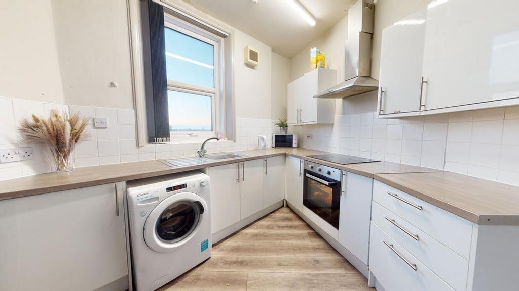 A bright and modern kitchen equipped with essen...