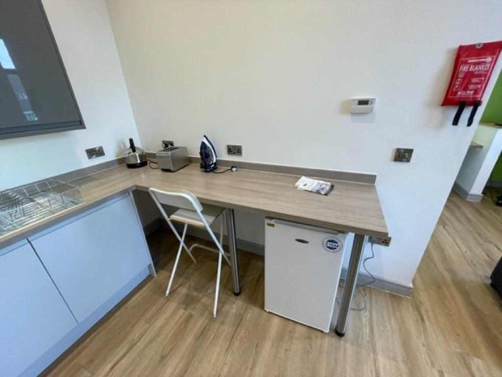Bright and clean kitchenette featuring a sleek ...