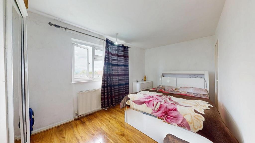 A bright and tidy double bedroom featuring a co...
