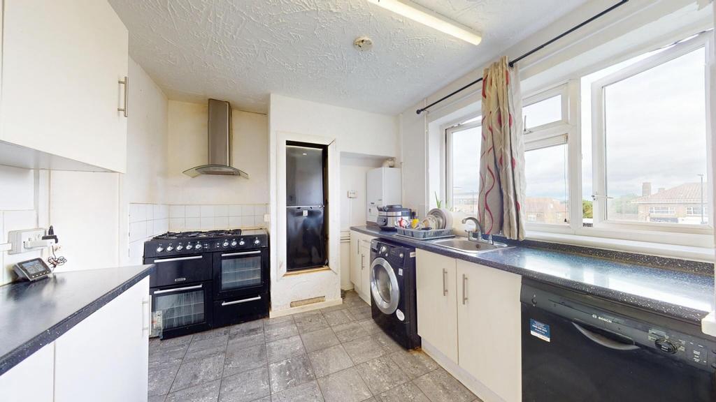 Bright and well-equipped kitchen featuring ampl...