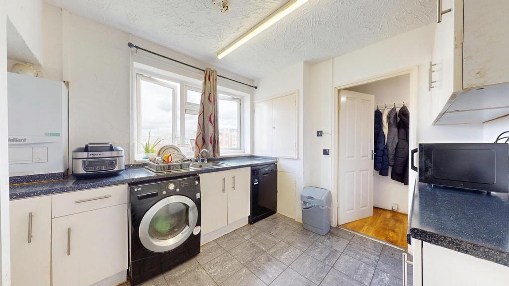 A bright, modern kitchen featuring ample counte...