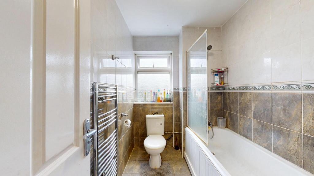 Bright and clean bathroom featuring a bath and ...