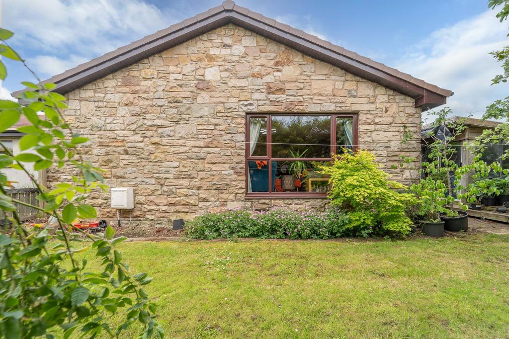 Side Of Property With Garden Room