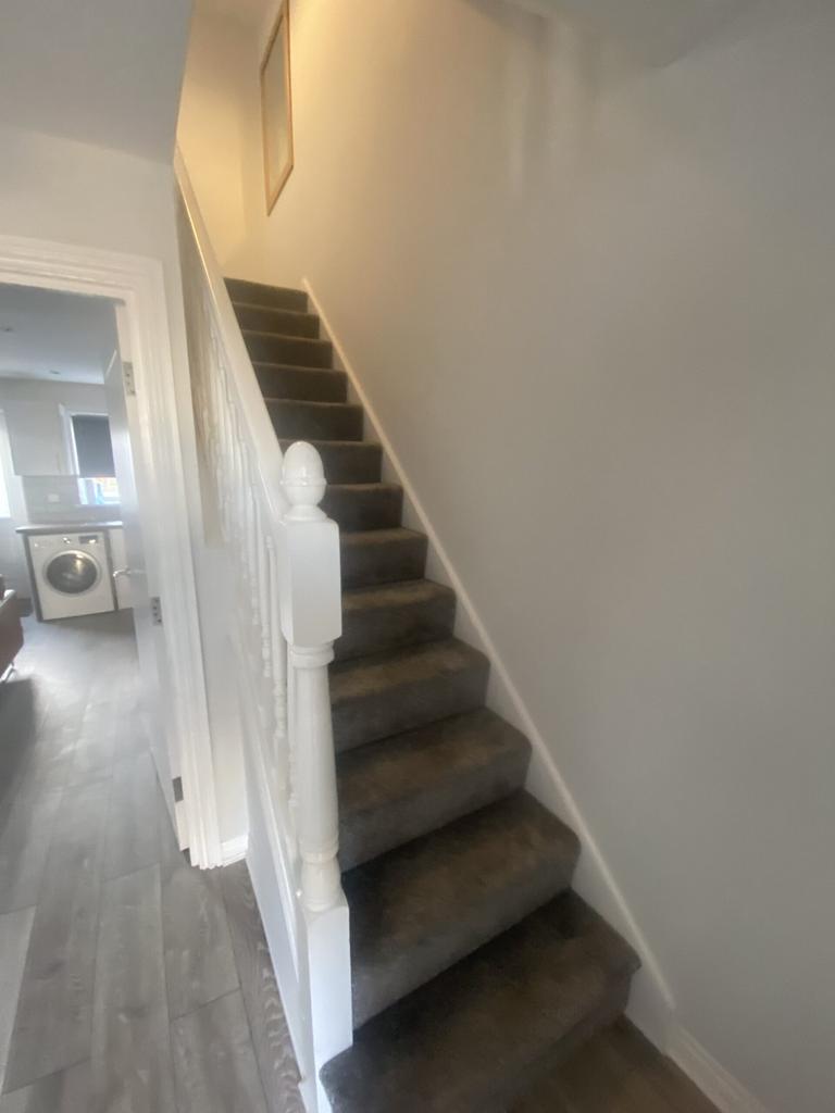 A well-maintained staircase leading to the uppe...