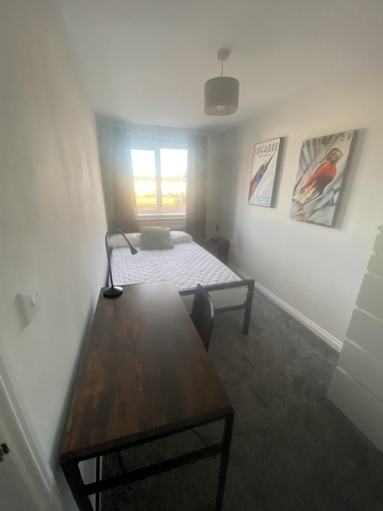 A bright and inviting double bedroom featuring ...