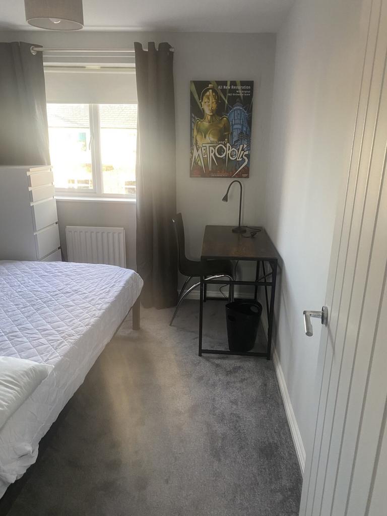 A bright and inviting double bedroom featuring ...