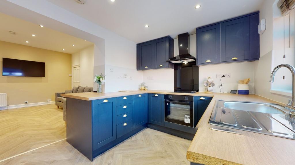 A modern and spacious kitchenette with stylish ...