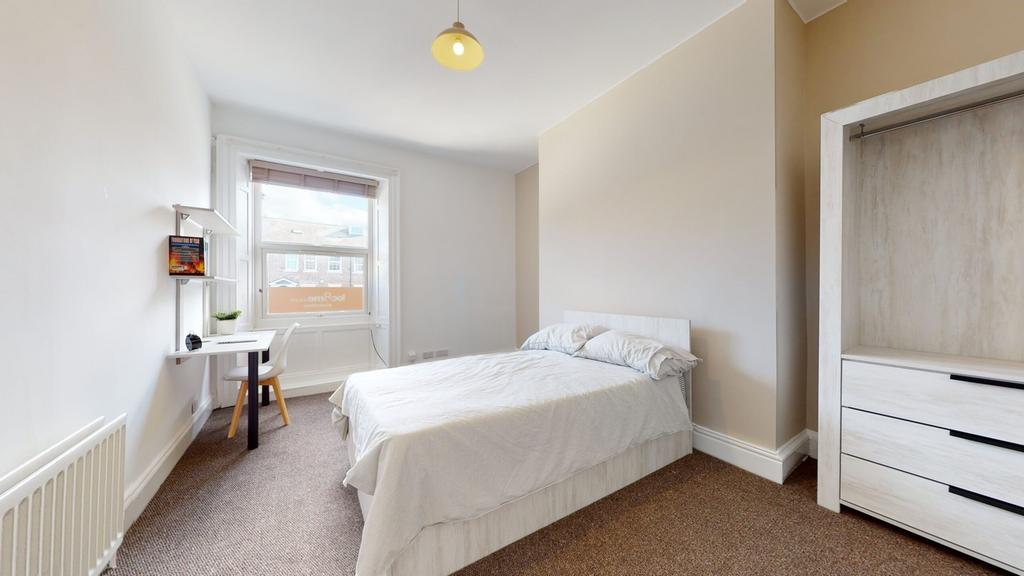 A spacious and inviting double bedroom with amp...