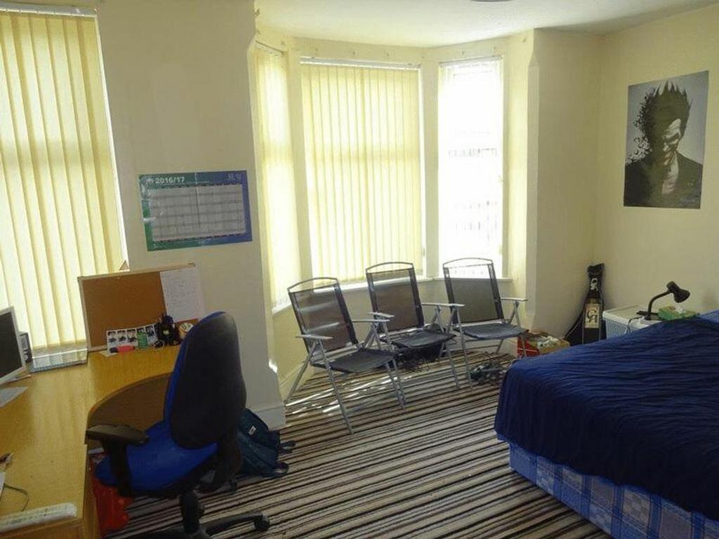 A spacious and well-lit double bedroom featurin...