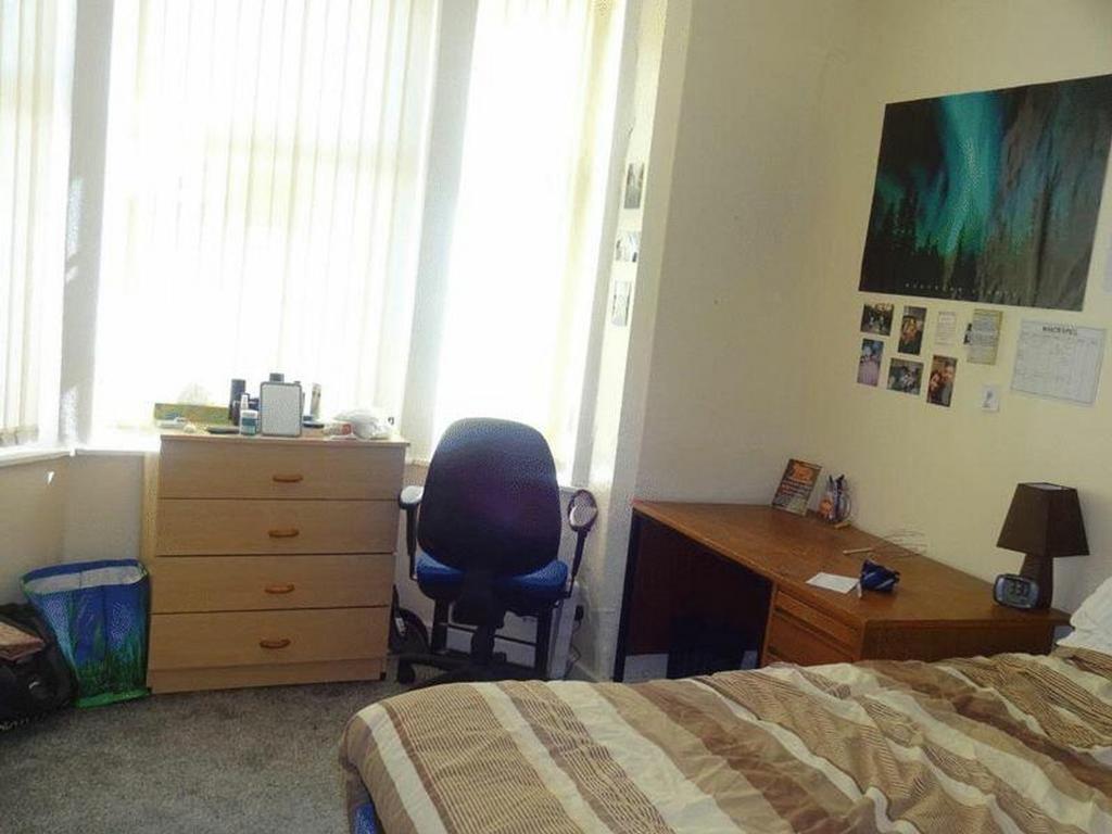 A bright and cozy double bedroom featuring ampl...