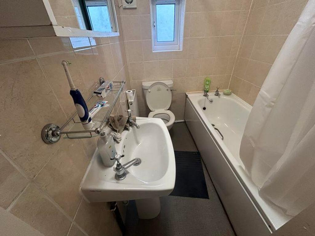 A tidy and functional bathroom featuring a bath...