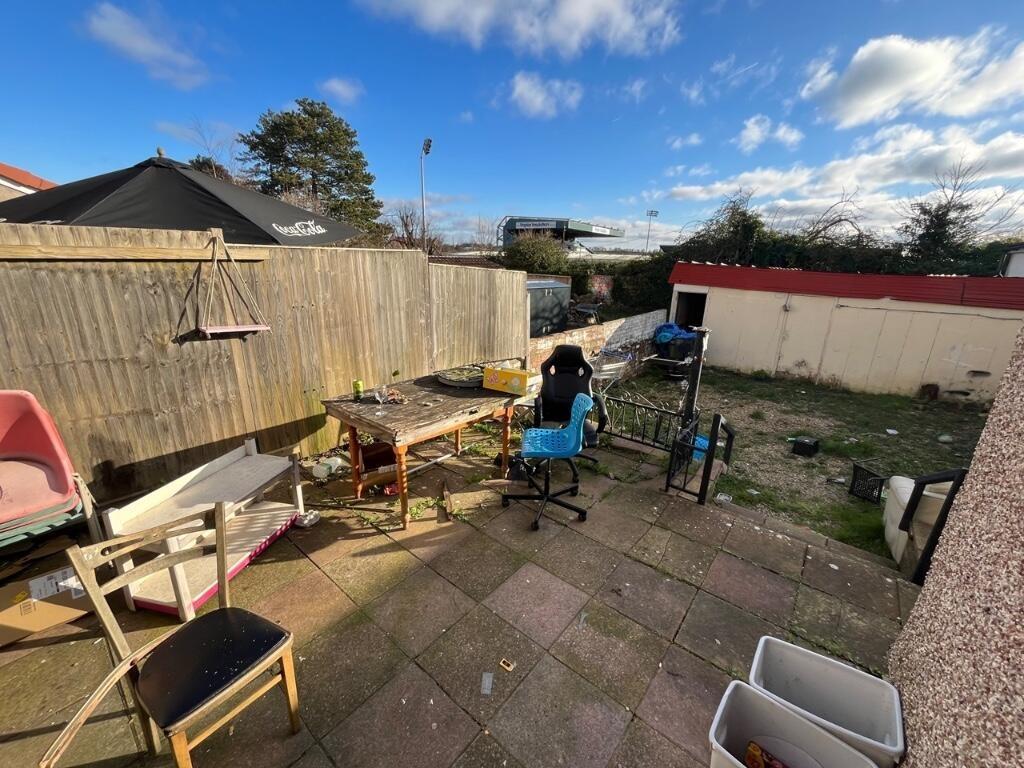 A sunny garden area featuring ample outdoor sea...