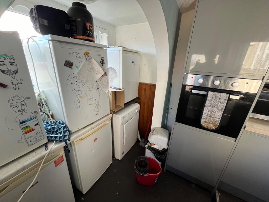 Compact kitchen featuring essential appliances ...