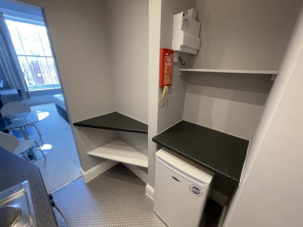 A neat and functional kitchenette area featurin...
