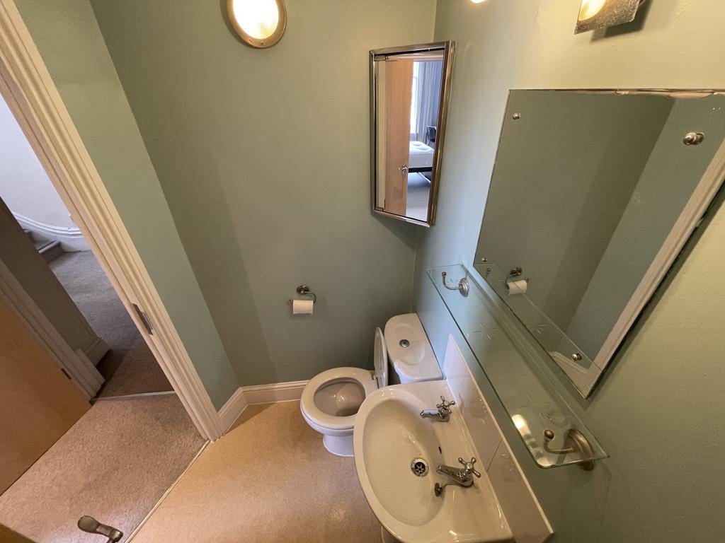 A clean and simple single toilet room featuring...