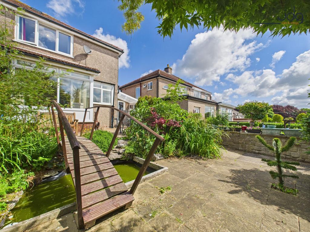 South-facing rear garden with bridge and small...
