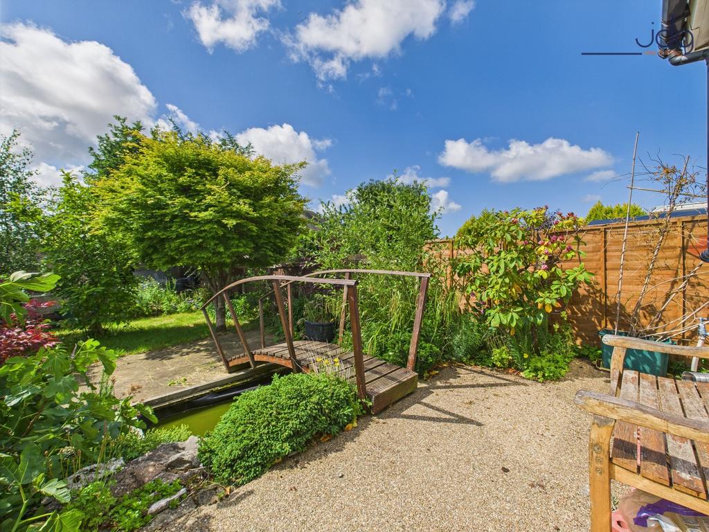 South-facing rear garden with bridge and small...