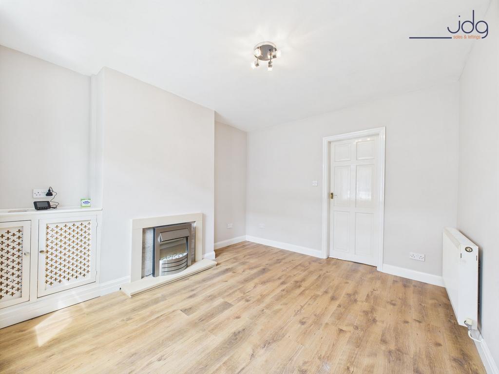 Lounge with wood-effect flooring and electric fire