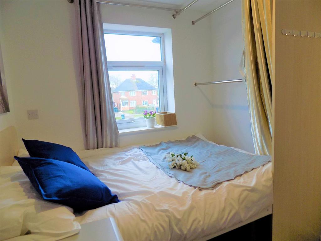 Cozy double bedroom featuring a comfortable bed...