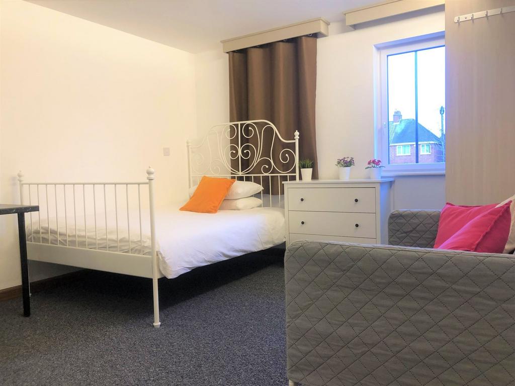 Bright and cozy single bedroom featuring a styl...