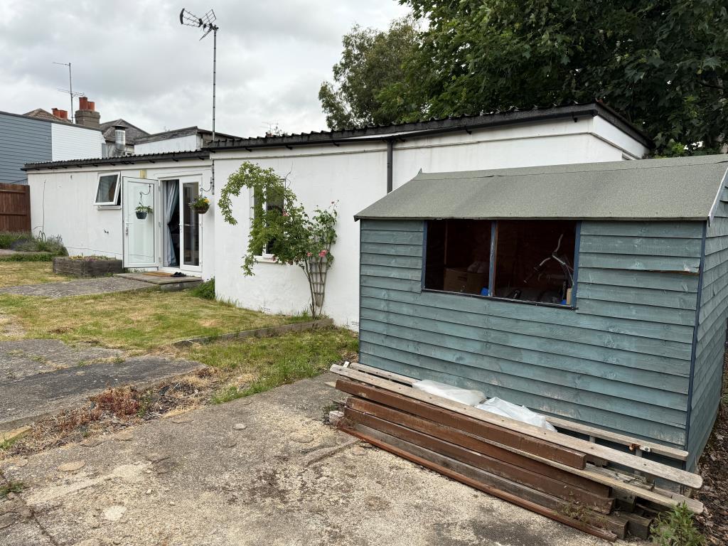 Rear elevation with patio area and shed