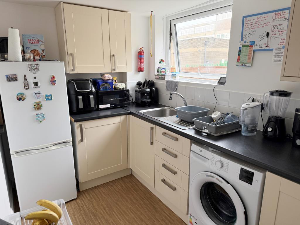 Kitchen with fitted units and window