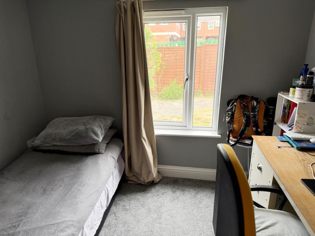 Second bedroom with window overlooking rear garden