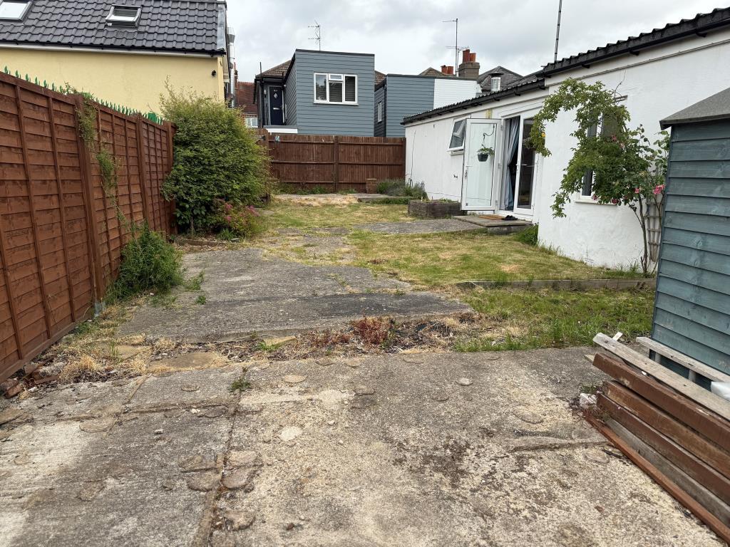 View of garden from rear showing lawn and patio