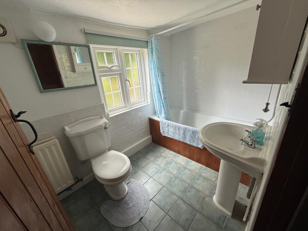 Bath with shower over, w/c and wash hand basin