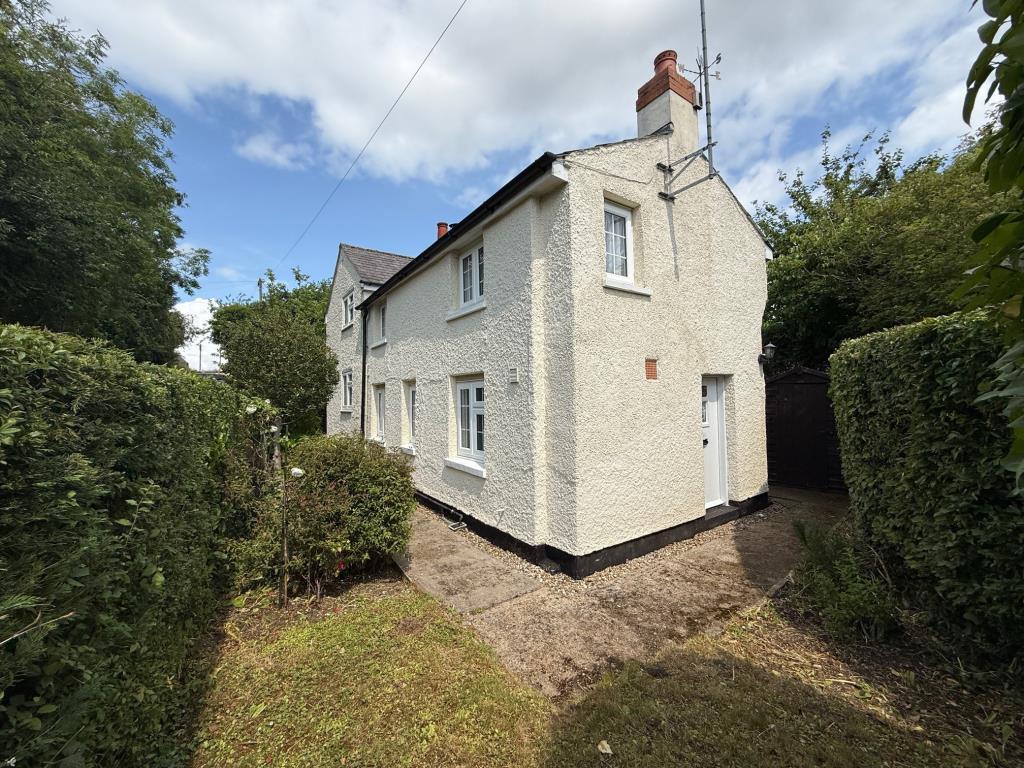 Exterior photo of cottage from lawn area