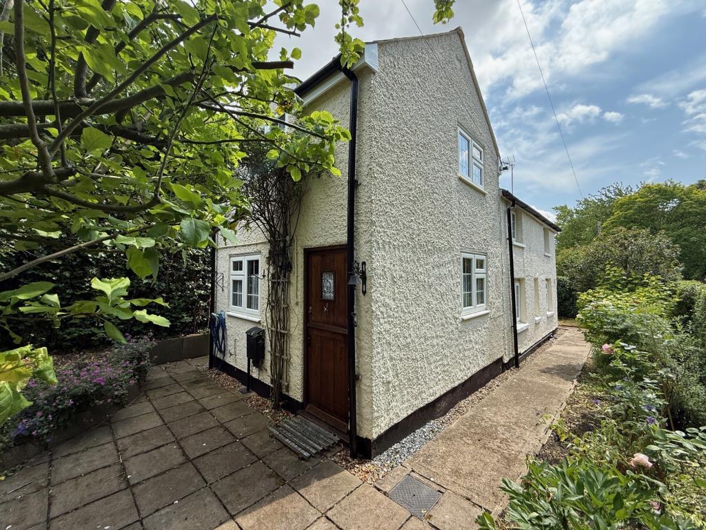 Exterior photo of cottage from lawn area