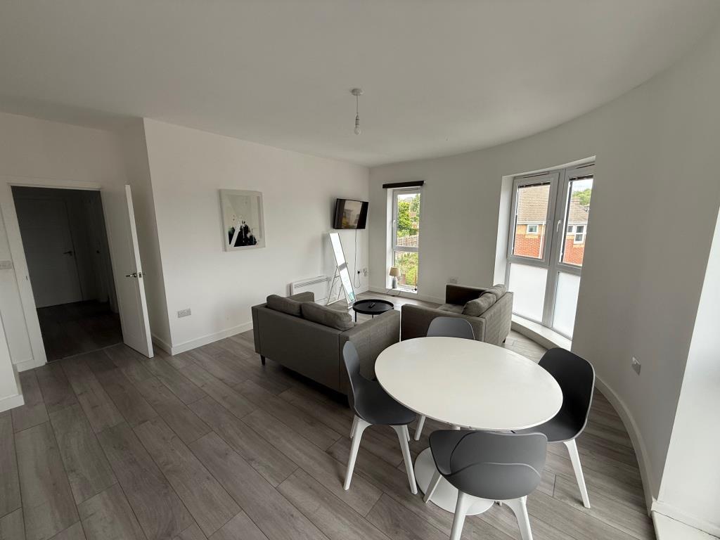 Living room with white painted walls and grey floo