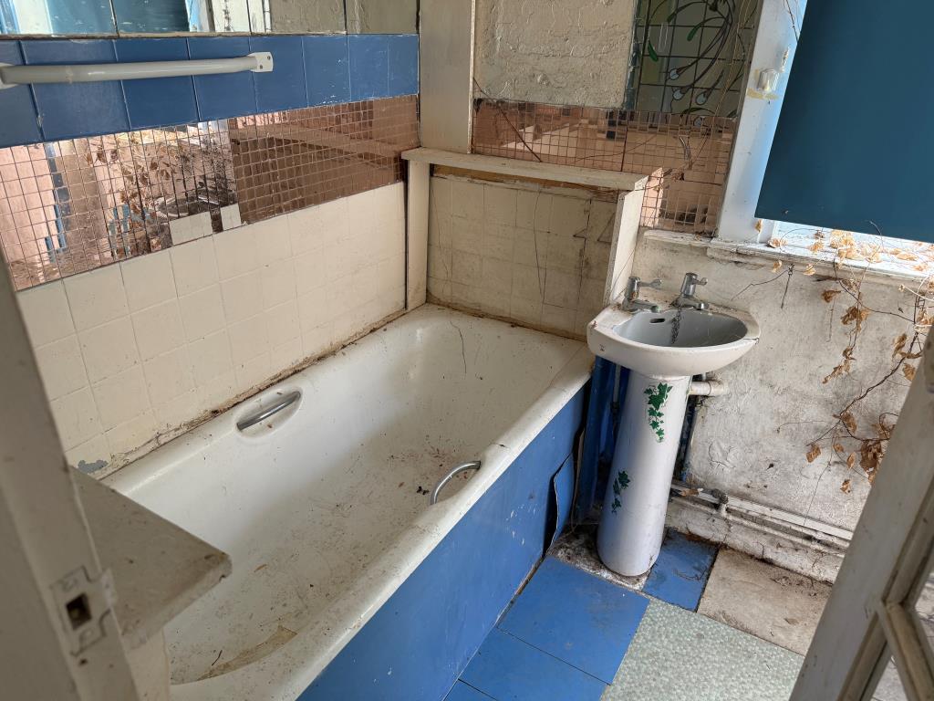 Bathroom with white bath and sink units