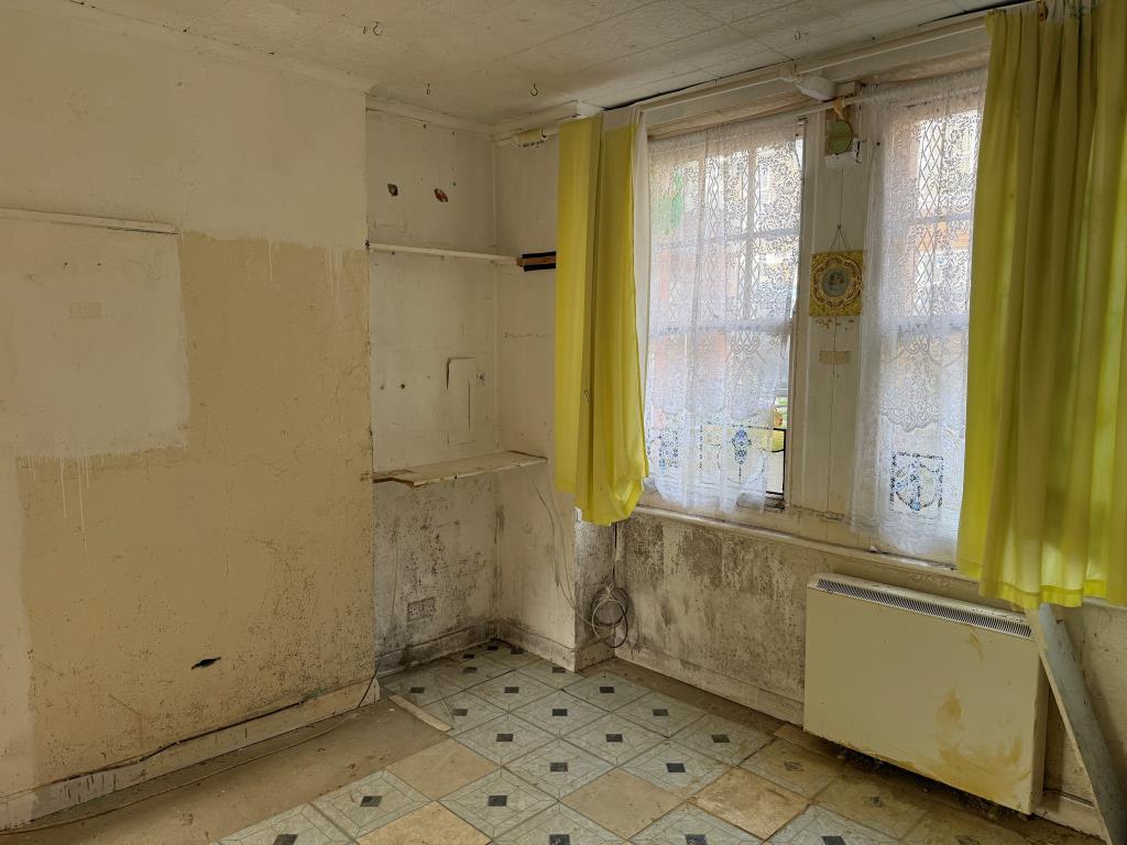 Studio sleeping area with front window onto street